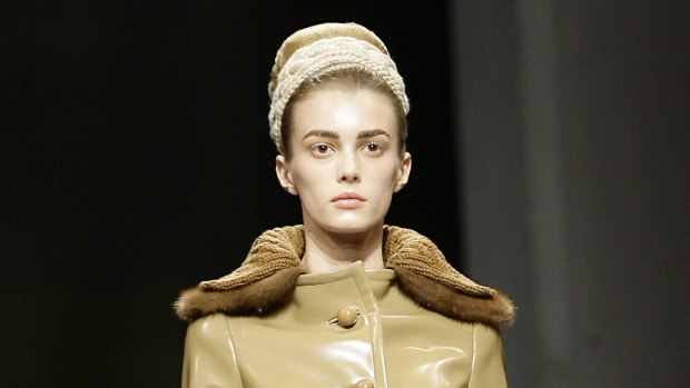 A model wears a coat with a fur trim from Prada's Fall-Winter 2010/2011 collection.