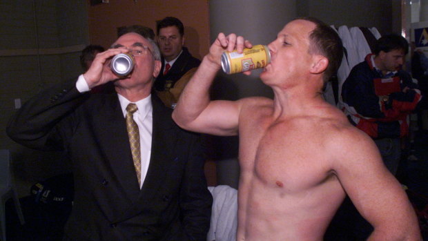 Walters enjoys a celebratory beer with Prime Minister John Howard after the Broncos’ 1998 grand final win.