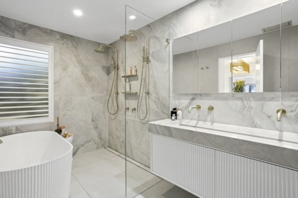 The master en suite features a free-standing bath, underfloor heating and brushed gold tapware.
