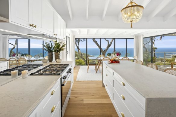The state-of-the-art gourmet kitchen has a stone island breakfast bar.
