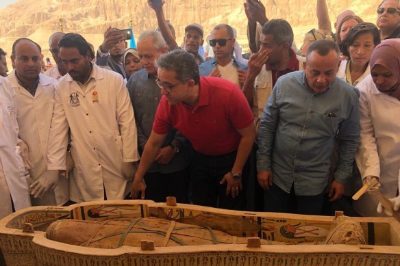 Egyptian Minister of Antiquities Khaled el-Anany, centre, reveals the details of 30 ancient wooden coffins recently discovered in the southern city of Luxor, Egypt. 
