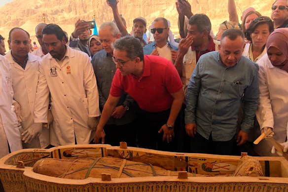 Egyptian Minister of Antiquities Khaled el-Anany, centre, reveals the details of 30 ancient wooden coffins recently discovered in the southern city of Luxor, Egypt. 