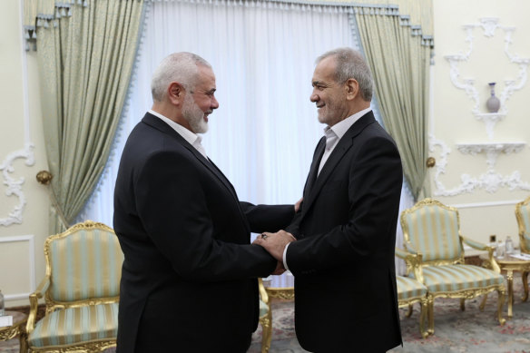 Iran President Masoud Pezeshkian, right, shakes hands with Hamas chief Ismail Haniyeh, who was killed by Israeli Defence Forces on Wednesday, hours after Pezeshkian’s swearing-in.