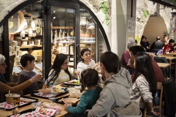 A family dines at the Mercato Centrale in Milan.