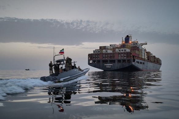 A Revolutionary Guard Navy (IRGC) speedboat approaches the cargo ship Epaminondas during what state media described as the seizure of one of two vessels accused of violations in the Strait of Hormuz.