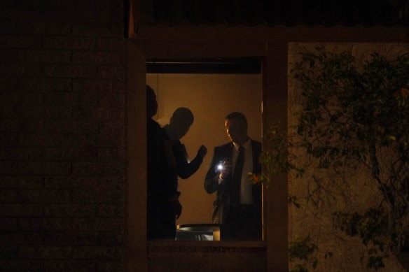 Investigators survey the scene at an office building after a shooting in Orange, California on Wednesday, March 31, 2021. 
