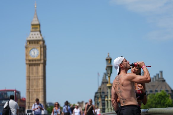 Londoners on Westminster Bridge trying to keep calm and carry on, amid heatwave warnings on Tuesday.