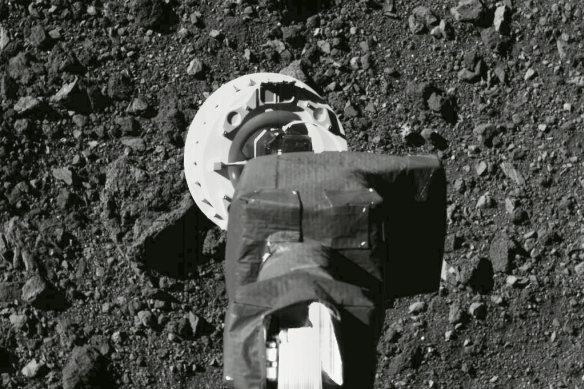 The sampling arm of the OSIRIS-REx spacecraft during a rehearsal for an approach to the "Nightingale" sample site on the surface of the asteroid Bennu. 