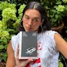 Dua Lipa poses with Helen Garner’s 2014 book.