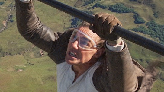 Tom Cruise says preparing for a stunt when he hung off the wing of a plane took “decades”.