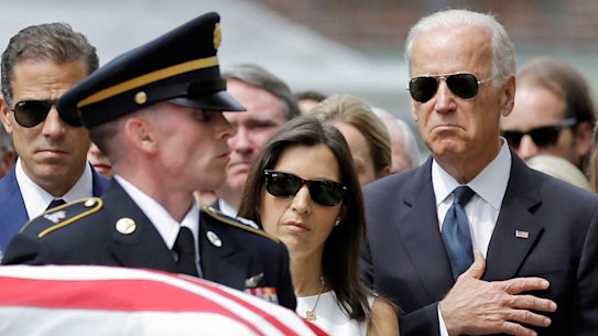 Joe Biden at his son Beau’s funeral next to his widow Hallie and brother Hunter.