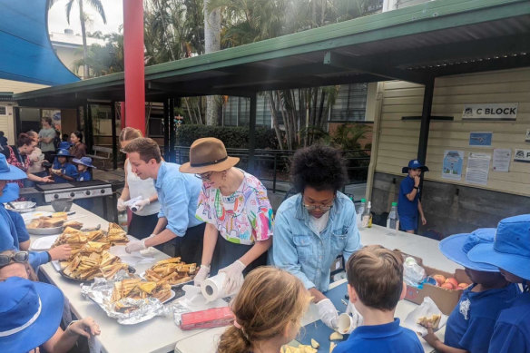 Serving at a barbecue for school kids in his area. Chandler-Mather uses his $19,500 Commonwealth car allowance to help fund local meal programs.