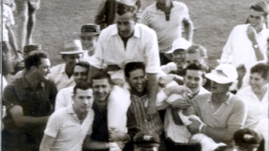 Ian Meckiff is chaired off the field by spectators after the innings.