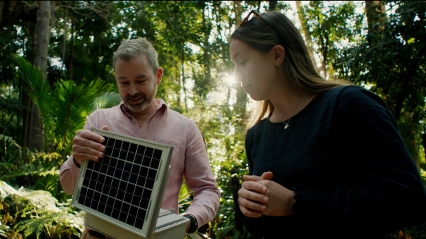 Professor Paul Roe, lead researcher at A20, and QUT research fellow Dr Daniella Teixeira check a recorder in the wild.