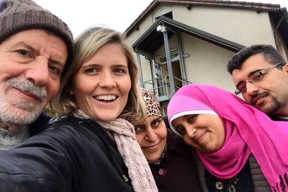 Sophie McNeill with Syrian refugee Nazieh Husein (left) and his wife and children in Germany. In her book McNeill tells of encountering Husein alone on the shores of Greece and helping him search for his family.