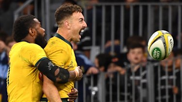 Hoodoo guru: Nic White celebrates scoring a try with Marika Koroibete.