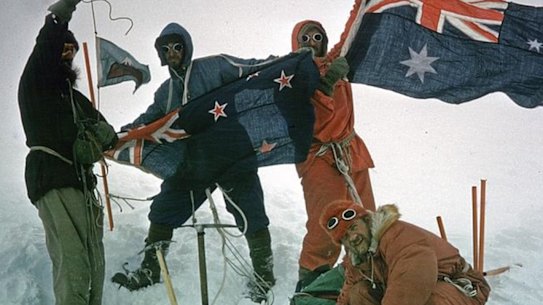Success: the expedition party raises flags at the top of Big Ben on Heard Island.