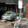 Emergency personnel at the scene of a crash at Elizabeth Street. The 87-year-old driver ploughed his car into the KT Mart on Wednesday afternoon.