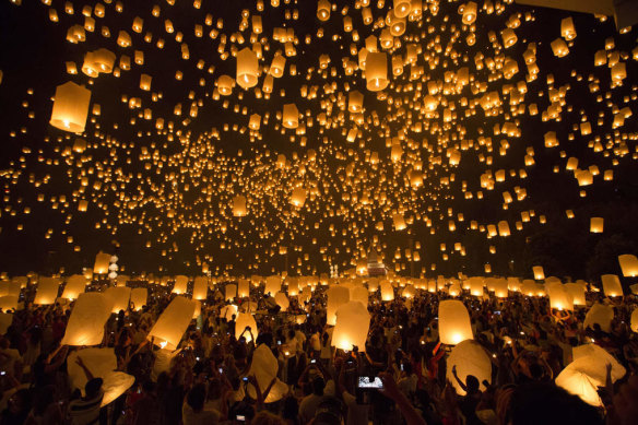 At the Yi Peng Lantern Festival, thousands of candlelit lanterns are sent floating into the night sky.