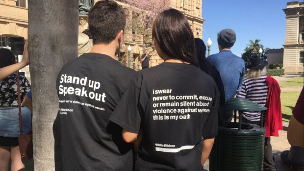 Men speak out against domestic violence on women at a rally in Brisbane's Queens Park. 
