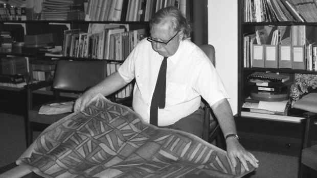 Professor Ronald Berndt at the University of WA with a rare Aboriginal painting.
