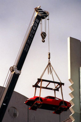 Adrian Valmorbida's $100,000 Ferrari Dino is moved by crane from his eight floor bedroom in 1998.