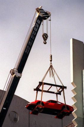 Adrian Valmorbida’s $100,000 Ferrari Dino is moved by crane.