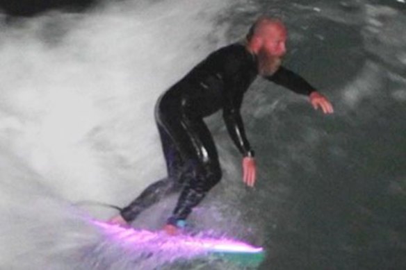 Blake Johnston surfs through the night.