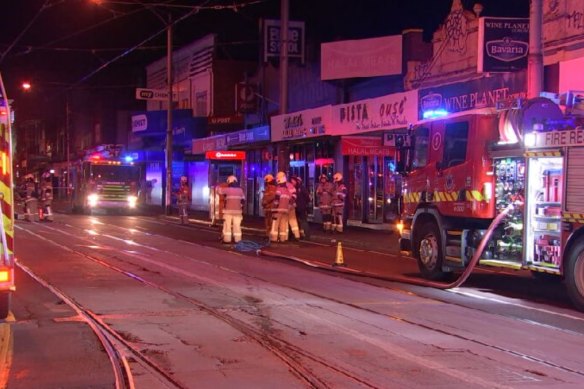 Firefighters outside a vape and tobacco store  that was firebombed in Melbourne.