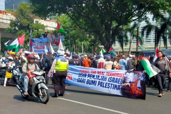Members of hardline Islamic groups protest outside the US embassy in Jakarta, which was being fortified with barbed wire.
