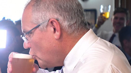 Scott Morrison sips his beer alongside the Liberal candidate for Herbert, Phillip Thompson, on Anzac Day.