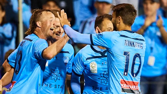Sydney FC celebrate Rhyan Grant's goal in their win over the Phoenix on Sunday. 