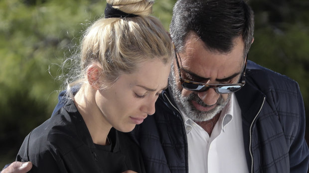 Viktoria Karyda, John Macris' widow, arrives at an Orthodox church for his funeral ceremony, south of Athens.