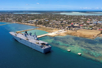 The Australian navy ship docks in Tonga to unload aid supplies.