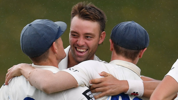 Got him: NSW's Harry Conway (centre) celebrates taking the wicket of Victoria's Matt Short on Wednesday.