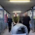 Pushing his bedding under the watchful eye of prison guards, a convicted monster on the move.