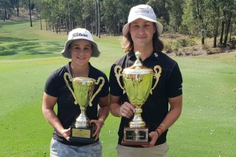 Ash Barty and Louis Dobbelaar with their trophies after winning the Brookwater Club Championship in Queensland in 2020.