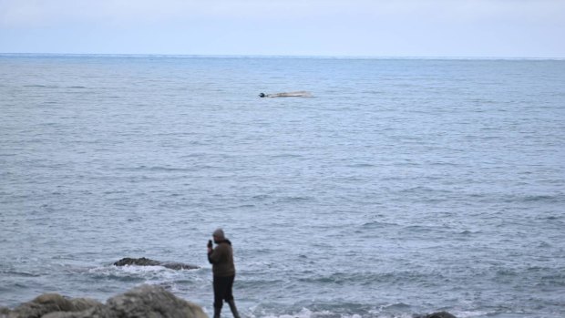 A person on the coast near where the boat capsized.