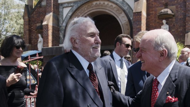 Rapprochement: One of the great feuds of Sydney has ended. John Laws and Alan Jones exchange pleasantries at the funeral of John Fordham in Paddington last November.