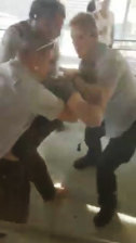 In mobile phone footage taken from inside the centre, the man is dragged away by three guards.