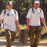 Shane Watson (left) and Shane Warne carry a jerrycan of water during the Australians' Queensland boot camp in 2006.