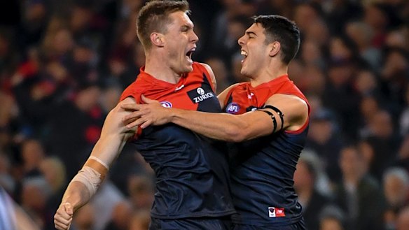 Tom McDonald and Christian Petracca celebrate a goal against the Cats.