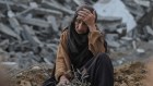 A Palestinian woman among rubble after Israeli shelling in the Nuseirat refugee camp in central Gaza.