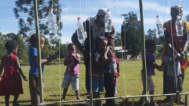 Young earthquake survivors learn how to properly wash their hands and prevent illness, at a UNICEF-supported child space in Mendi, PNG. 
