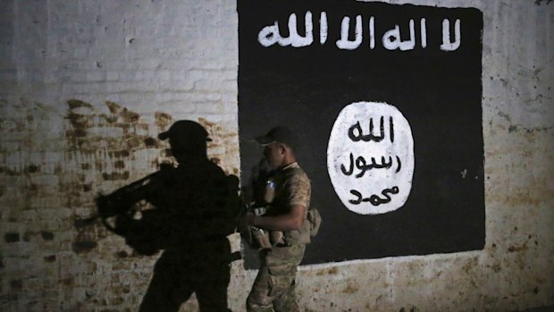 An Iraqi soldier inspects a train tunnel that was turned into a training camp for IS fighters. 