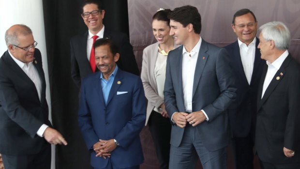Prime Minister Scott Morrison, left, shares a joke with Brunei Sultan Haji Hassanal Bolkiah (in blue) and other leaders, at the APEC summit in Port Moresby, Papua New Guinea, in November. 