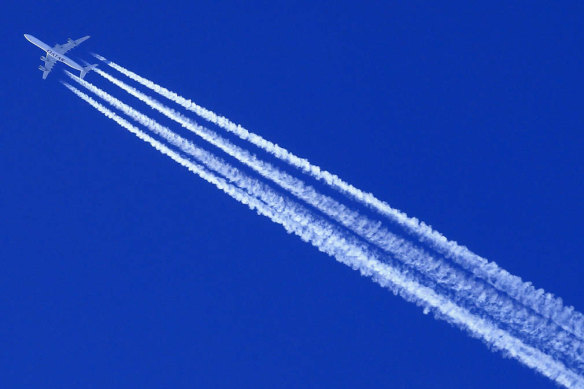 A Qatar Airways Airbus A 340 airplane leaves contrails in the sky.