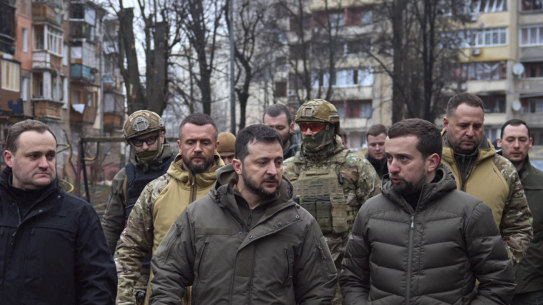 Ukrainian President Volodymyr Zelensky inspects damage outside the capital Kyiv in November.
