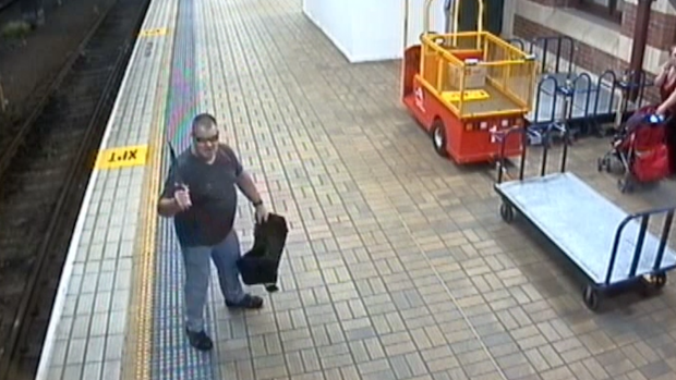 Mr Thomson brandishes a knife shortly before falling onto the train tracks.