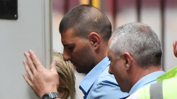 Jospeh Esmaili (centre) departs the Supreme Court of Victori on Wednesday to serve his 10-year sentence.